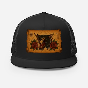 May include: Black trucker hat featuring a vintage-style tattoo design. The design includes a snarling black panther, red roses, and a treasure map with crossed swords. The hat has a mesh back and a curved brim.