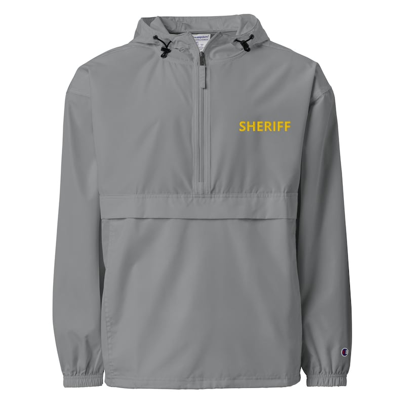 May include: A gray hooded jacket with a zipper closure and a yellow embroidered "SHERIFF" on the front.
