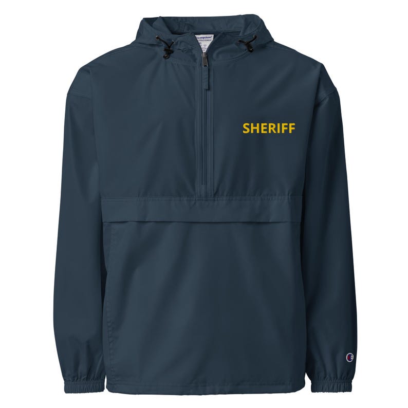 May include: A navy blue hooded jacket with a zipper closure and a yellow embroidered "SHERIFF" logo on the front.