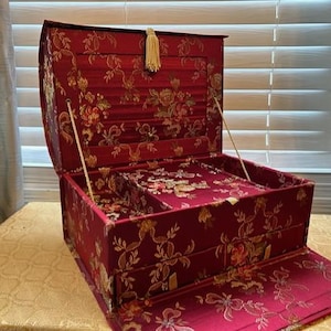 Vintage ASIAN inspired RED brocade jewelry box with tons of storage,mirror,ring boxes,roll top hidden storage.Beautiful condition!