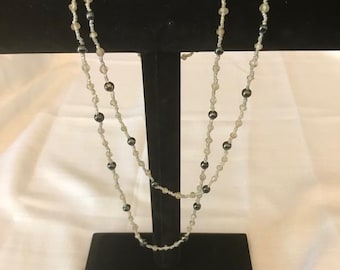 White and black tone, women&#39;s, beaded,extra long necklace. Shimmery BOHO necklace 48 inches long. Black beads are very shiny