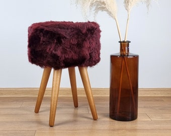 Burgundy red sheepskin accent chair with oak legs | Genuine fur interior details | Luxurious fur tabouret | Red vanity stool | Fluffy stool