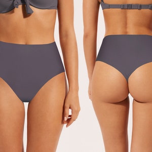 May include: High-waisted bikini bottoms in a dark gray color. The bottoms have a thong back style.