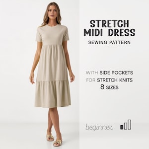 May include: A woman wearing a beige midi dress with short sleeves and a tiered skirt. The dress is made from a soft fabric. Text on the right reads "STRETCH MIDI DRESS SEWING PATTERN" and "WITH SIDE POCKETS FOR STRETCH KNITS 8 SIZES".