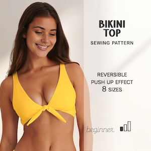 May include: A vibrant yellow bikini top with a tie detail. The image features text: "BIKINI TOP SEWING PATTERN", "REVERSIBLE PUSH UP EFFECT 8 SIZES", and "beginner". The model is smiling.