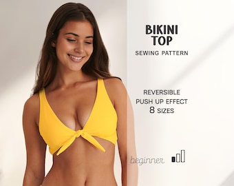 May include: A bright yellow bikini top with a tie front. The image includes text that reads "BIKINI TOP SEWING PATTERN", "REVERSIBLE PUSH UP EFFECT 8 SIZES", and "beginner". The model is smiling.