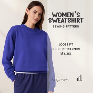 May include: A woman wearing a blue sweatshirt and navy blue pants. The image includes text that reads "WOMEN'S SWEATSHIRT SEWING PATTERN" and details about the pattern, including "LOOSE FIT FOR STRETCH KNITS 8 SIZES" and "beginner".