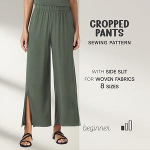 May include: Olive green cropped pants with side slits, part of a sewing pattern. The text on the image reads "CROPPED PANTS SEWING PATTERN WITH SIDE SLIT FOR WOVEN FABRICS 8 SIZES beginner". The model is wearing black sandals.