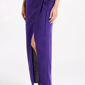 May include: A long purple wrap skirt with a side slit and a tie at the waist.
