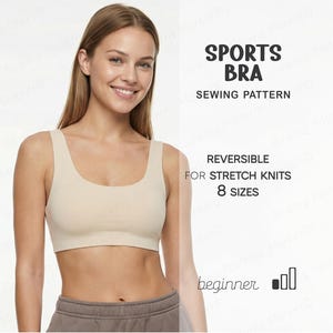 May include: A beige sports bra with a square neckline. The image includes text that reads "SPORTS BRA SEWING PATTERN" and "REVERSIBLE FOR STRETCH KNITS 8 SIZES". The bra is shown on a person wearing grey sweatpants.