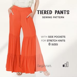 May include: Vibrant orange tiered trousers with side pockets, presented as a sewing pattern. The image text states "TIERED PANTS SEWING PATTERN" and "WITH SIDE POCKETS FOR STRETCH KNITS 8 SIZES". The word "beginner" is also visible.