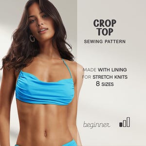 May include: A turquoise crop top with a halter neck design. The image includes text that reads "CROP TOP SEWING PATTERN" and "MADE WITH LINING FOR STRETCH KNITS 8 SIZES". The pattern is for beginners.