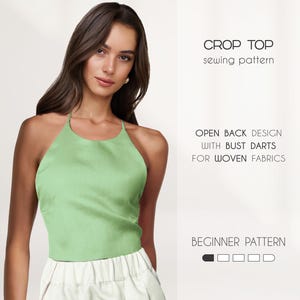 May include: A pale green crop top with a halter neck, worn with a white skirt. The image includes text: "CROP TOP sewing pattern", "OPEN BACK DESIGN WITH BUST DARTS FOR WOVEN FABRICS", and "BEGINNER PATTERN".