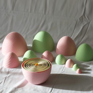 May include: A white ceramic mug with a black handle and the text "But First, Coffee" in a black, handwritten-style font. The mug is on a white surface.