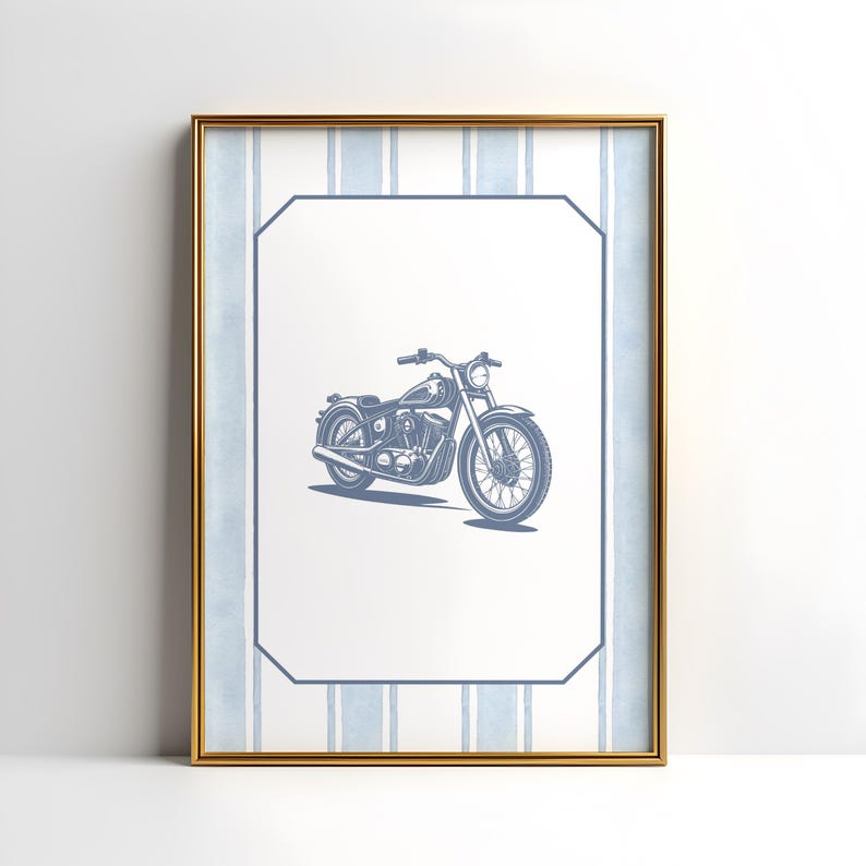 May include: Framed print featuring a blue motorcycle illustration. The artwork is set against a white background with a blue striped border and a gold frame. The motorcycle is detailed with visible engine and wheel spokes.