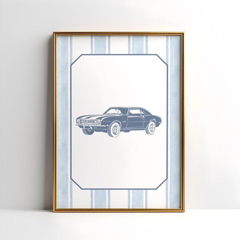 May include: Framed print featuring a blue classic car illustration. The car is centered on a white background with a blue border and a striped blue and white background. The frame is gold.
