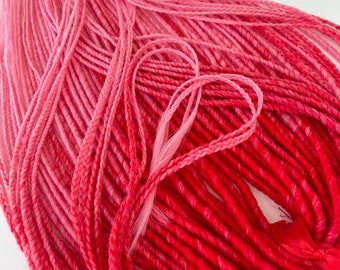 May include: A bundle of pink and red ombre synthetic dreadlocks. The dreadlocks are made of kanekalon hair and are approximately 24 inches long.