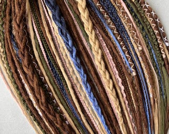 May include: A collection of synthetic dreadlocks in various colors, including brown, beige, blue, green, and pink. The dreadlocks are arranged in a fan shape and are ready to be added to natural hair.