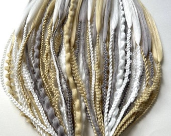 May include: A bundle of synthetic hair extensions in shades of white, gray, and beige. The extensions are braided and tied together with a rubber band.