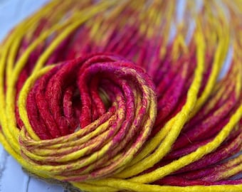 May include: A bundle of synthetic dreadlocks in yellow and pink ombre colors. The dreadlocks are made of kanekalon hair and are ready to be installed.