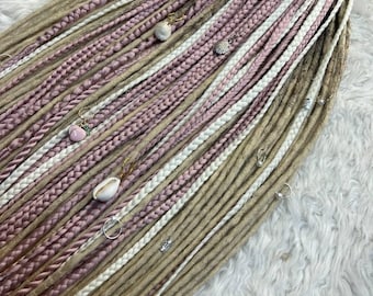 May include: A set of synthetic dreadlocks in shades of brown, white, and pink. The dreadlocks are decorated with small seashells and beads.