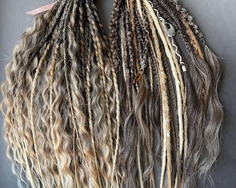 May include: Two bundles of dreadlocks in shades of brown, blonde, and gray, tied with pink ribbons. The dreadlocks have a mix of textures, including wavy and straight sections, and are arranged against a gray background.