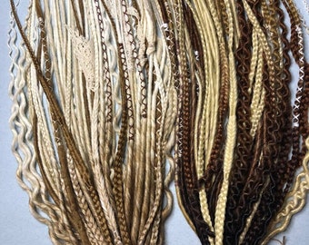 May include: A set of synthetic hair extensions in various shades of brown, blonde, and white. The extensions are braided and tied together with a string.