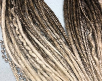 May include: A set of brown and blonde ombre synthetic dreadlocks. The dreadlocks are arranged in a circle and are ready to be installed.