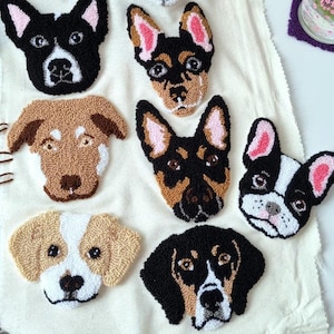 May include: A collection of eight different dog breeds, each with a unique personality, are depicted in a punch needle embroidery style. The dogs are all facing forward and have a variety of colors and patterns.