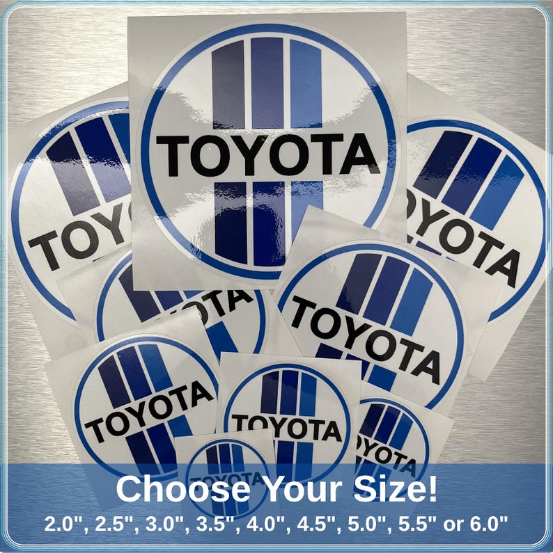 May include: A selection of white and blue Toyota logo stickers in different sizes. Each sticker displays the Toyota name in black, inside a white circle with blue stripes. The text "Choose Your Size!" is at the bottom, with sizes from 5.08 cm to 15.24 cm.