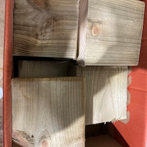May include: Four unfinished wooden blocks in a cardboard box. The blocks are square and have a natural wood grain.