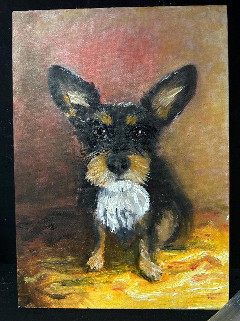 May include: Oil painting of a small dog with black and tan fur, large ears, and a white ruff. The dog is centered against a background of warm colours, with a yellow and gold foreground.