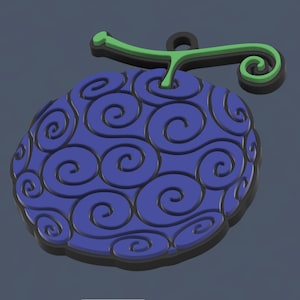 Puede incluir: Una fruta impresa en 3D azul y negra con un tallo verde y patrones en espiral. La fruta es un símbolo popular de la serie de anime One Piece.