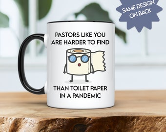 May include: White coffee mug with a black rim and handle. The mug has a cartoon image of a roll of toilet paper with sunglasses and the text "Pastors like you are harder to find than toilet paper in a pandemic".