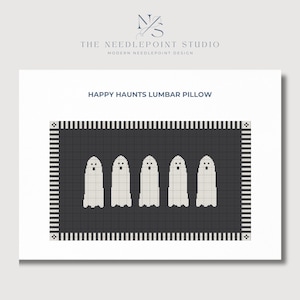 May include: A black and white needlepoint lumbar pillow with a design of five white ghosts on a black background. The pillow has a black and white striped border. The text "HAPPY HAUNTS LUMBAR PILLOW" is above the image.