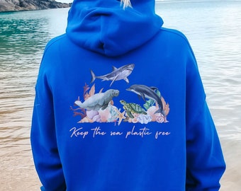 May include: A royal blue hoodie with a graphic of marine life, including a shark, dolphin, sea turtle, and manatee. The graphic is surrounded by coral and seaweed. The text "Keep the sea plastic free" is printed below the graphic.