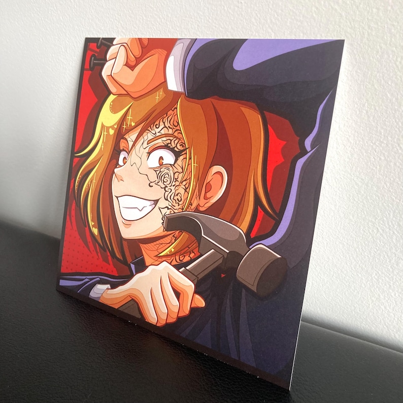 May include: A square art print featuring a stylized anime character with short brown hair and intricate floral tattoos on the face. The character holds a dark grey hammer against a vibrant red background with a dotted comic book style texture.