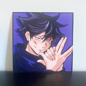 May include: A square art print featuring an anime-style character with spiky black hair and a dark blue high-collar garment. The character has visible red marks on their face and is making a hand gesture. The background is a solid purple color.