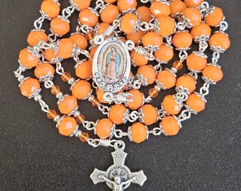 R098- Handmade rosary. Tangerine orange milk glass beads.  Our Lady of Guadalupe.  St. Benedict crucifix.