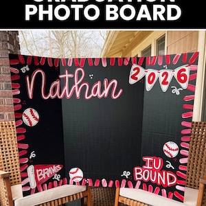 May include: A black tri-fold graduation photo board featuring hand-painted red and white baseball-themed decorations. The board displays the name Nathan, the year 2026 on pennants, the text IU BOUND, and a pennant labelled BRAVES in red and white.