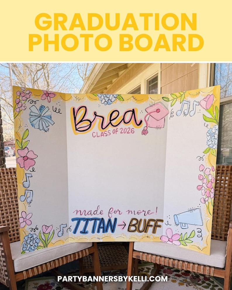 May include: A tri-fold white graduation photo board featuring hand-drawn illustrations of flowers, musical notes, a megaphone, and a graduation cap. The text reads Brea Class of 2026 and made for more! TITAN to BUFF in colourful lettering.