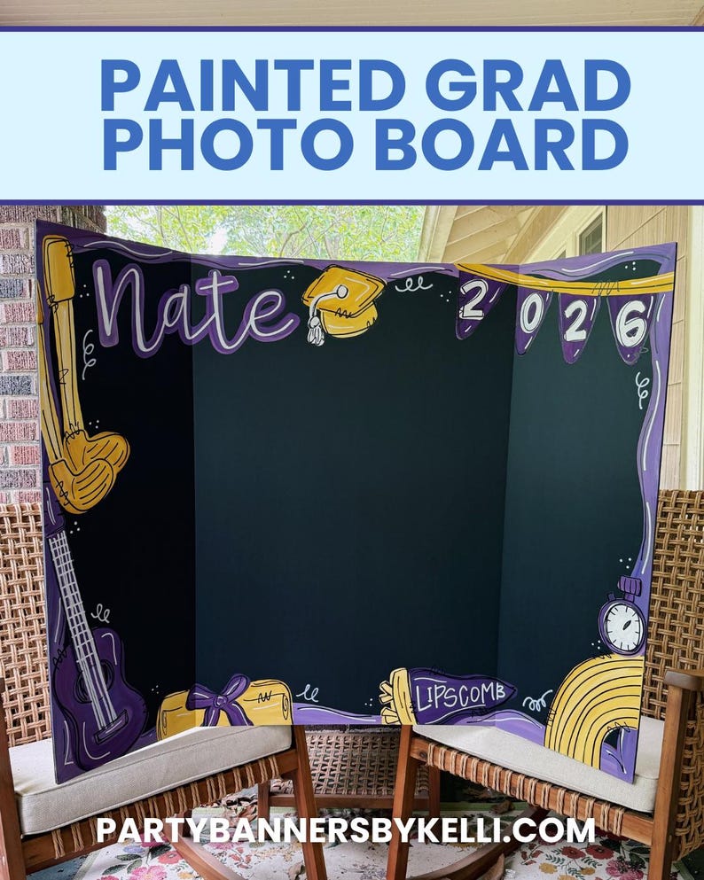 May include: A tri-fold black display board featuring hand-painted purple and yellow graduation-themed illustrations. The board displays the name Nate, the year 2026, a graduation cap, a guitar, a diploma, and the text Lipscomb in yellow paint.
