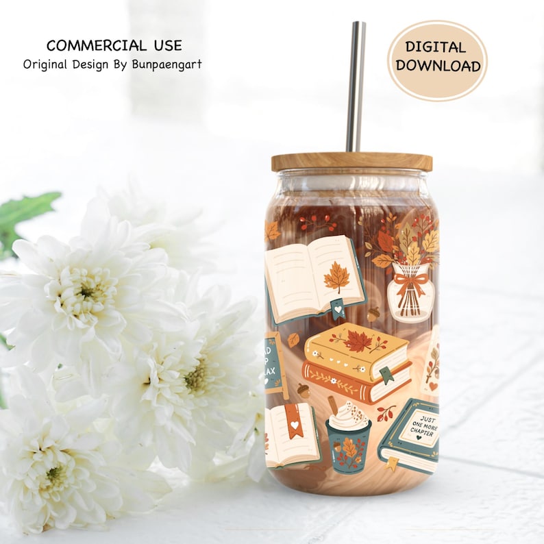 May include: A glass tumbler with a bamboo lid and a metal straw, featuring a printed design of open books, a vase with autumn leaves, and a cup of coffee. The text on the books includes the phrase Just One More Chapter in a fall color palette.