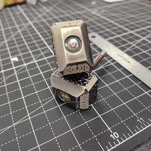 May include: A set of three ceramic mugs with a speckled, matte finish. The mugs are in shades of cream, light gray, and dark gray. Each mug has a simple, minimalist design, perfect for coffee or tea.