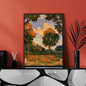 May include: A framed rectangular wall art print depicting a pumpkin patch at dusk. The scene features rows of orange pumpkins under large trees, illuminated by hanging string lights against a soft blue and orange sky with fluffy clouds.