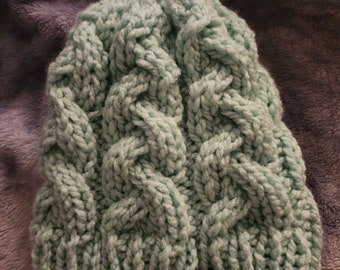 Light aqua cable knit hat.