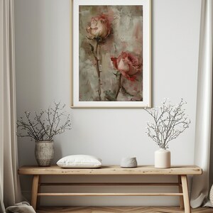 May include: A framed painting of two pink roses with green stems and thorns on a light gray background.