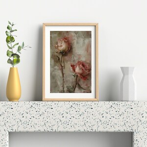 May include: A framed painting of two pink roses with a textured background. The roses are in a muted pink color and have a faded appearance. The painting is in a light wood frame.