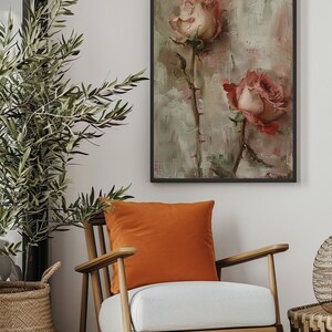 May include: A framed painting of two pink roses with green stems and leaves on a textured background. The painting is in a black frame and is hanging on a white wall.