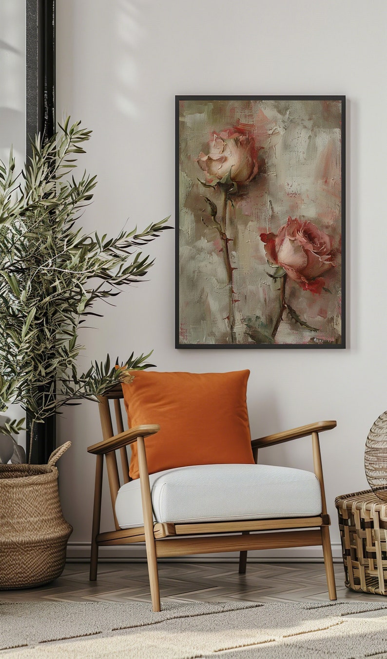 May include: A framed painting of two pink roses with green stems and leaves on a textured background. The painting is in a black frame and is hanging on a white wall.